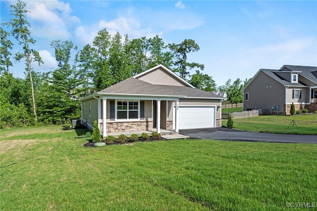 view of front facade with a garage, a porch, and a front yard