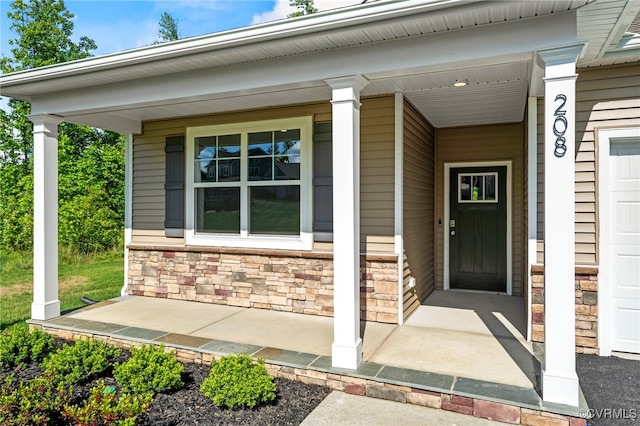 view of exterior entry with a porch