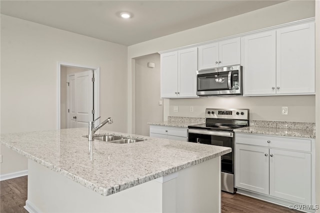 kitchen featuring sink, an island with sink, white cabinets, and appliances with stainless steel finishes