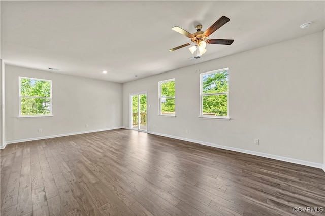 spare room featuring dark wood-type flooring and ceiling fan