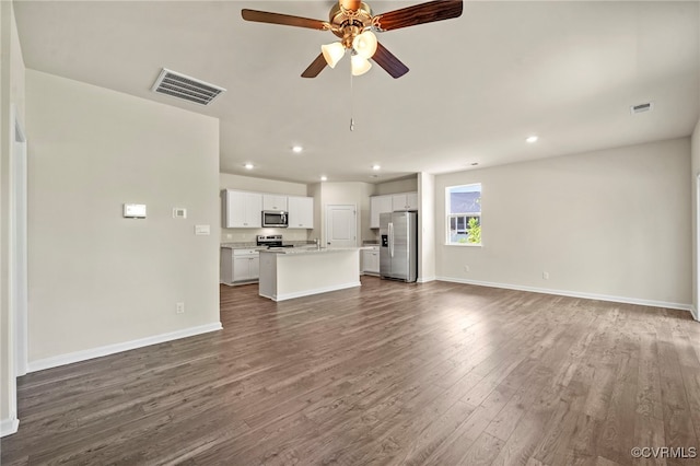 unfurnished living room with hardwood / wood-style flooring and ceiling fan