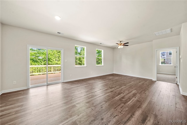 unfurnished living room featuring dark hardwood / wood-style floors and ceiling fan