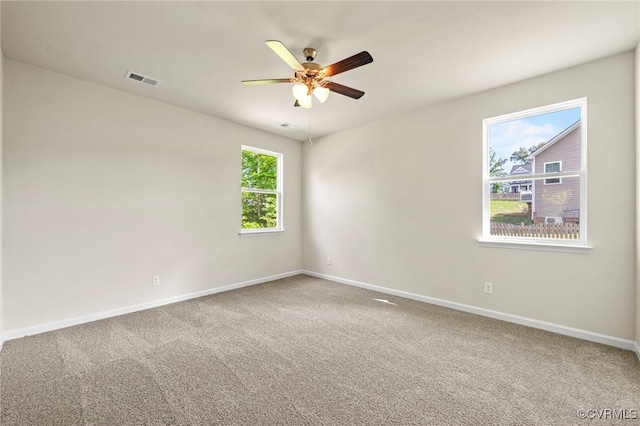 spare room featuring ceiling fan and carpet