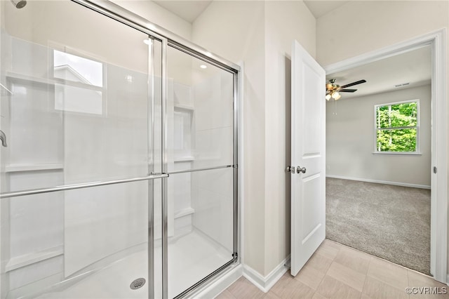 bathroom with an enclosed shower and ceiling fan