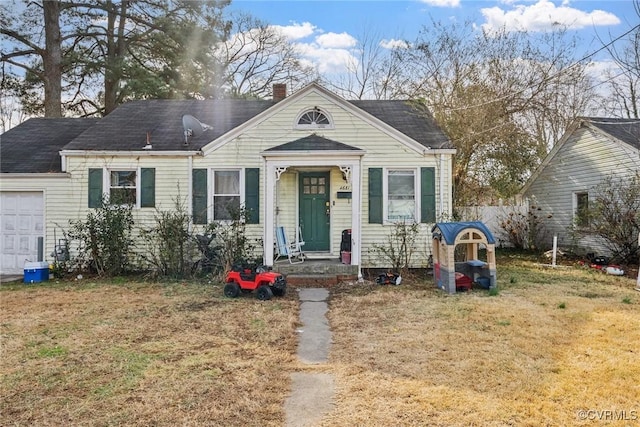 bungalow-style house featuring a garage and a front yard