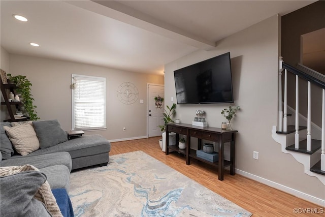 living room featuring hardwood / wood-style flooring and beam ceiling