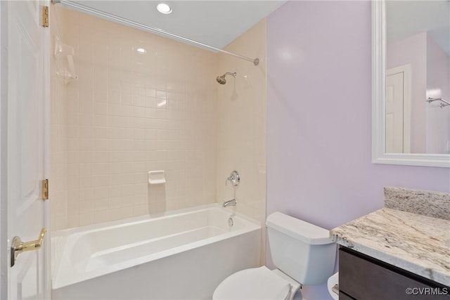 full bathroom featuring vanity, toilet, and tiled shower / bath