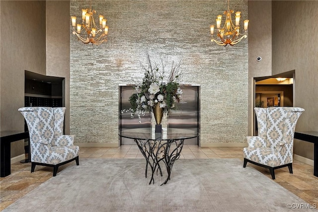 sitting room featuring a notable chandelier, tile patterned floors, and a high ceiling