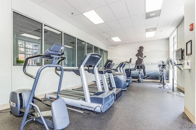 gym with a wealth of natural light and a paneled ceiling