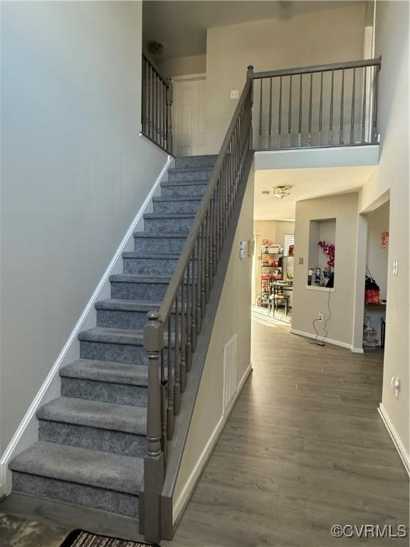 stairs featuring hardwood / wood-style flooring