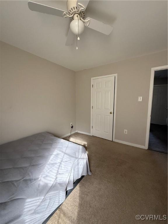 unfurnished bedroom with ceiling fan and carpet