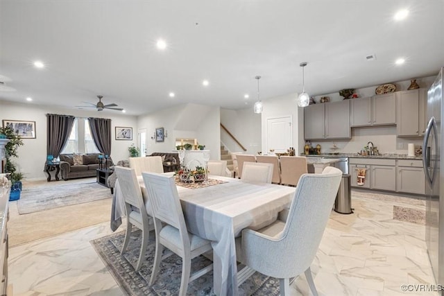 dining space with sink and ceiling fan