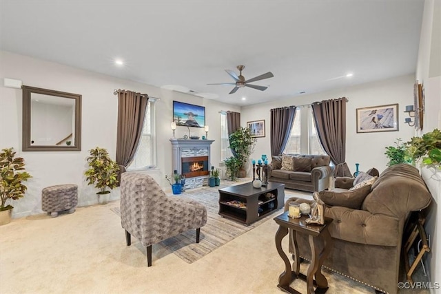 living room featuring light colored carpet and ceiling fan