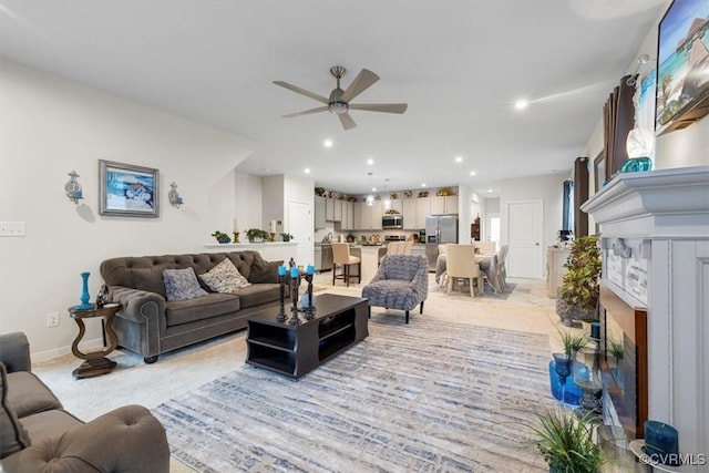 carpeted living room with ceiling fan