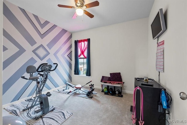 workout area featuring ceiling fan and carpet flooring