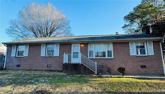 view of front of property with cooling unit and a front yard