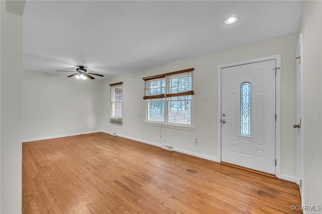 foyer with ceiling fan and light hardwood / wood-style flooring