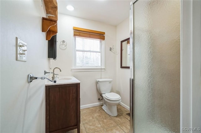 bathroom featuring tile patterned floors, vanity, toilet, and an enclosed shower