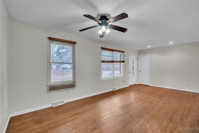 empty room featuring hardwood / wood-style flooring and ceiling fan