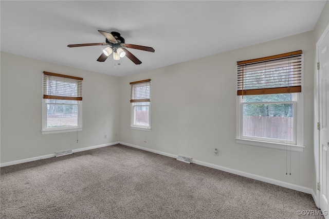 carpeted spare room featuring ceiling fan