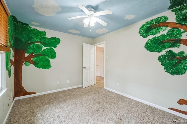 carpeted empty room with ceiling fan