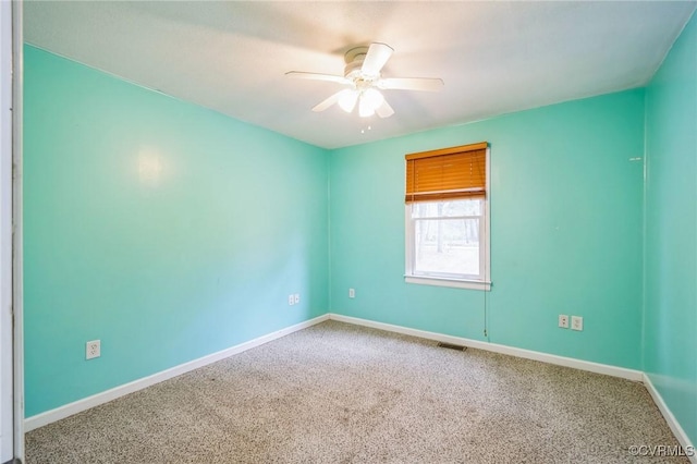 empty room featuring carpet floors and ceiling fan