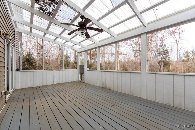 wooden deck with ceiling fan and a pergola