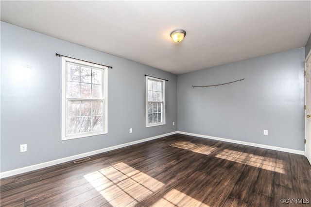 spare room featuring wood-type flooring