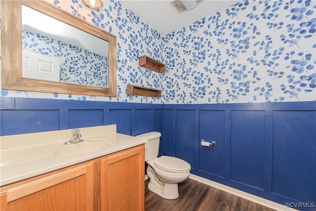 bathroom featuring vanity, hardwood / wood-style floors, and toilet