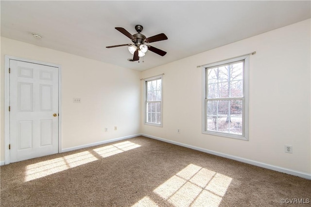 carpeted spare room with ceiling fan