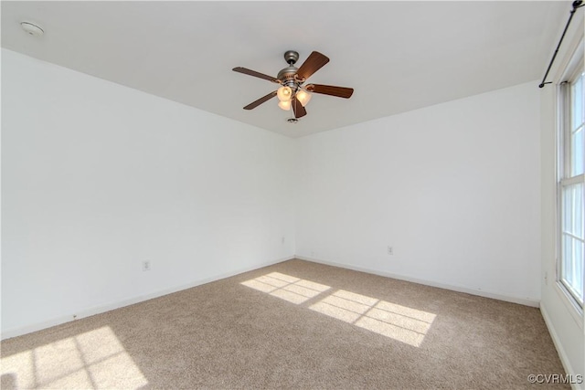 spare room featuring ceiling fan and light colored carpet