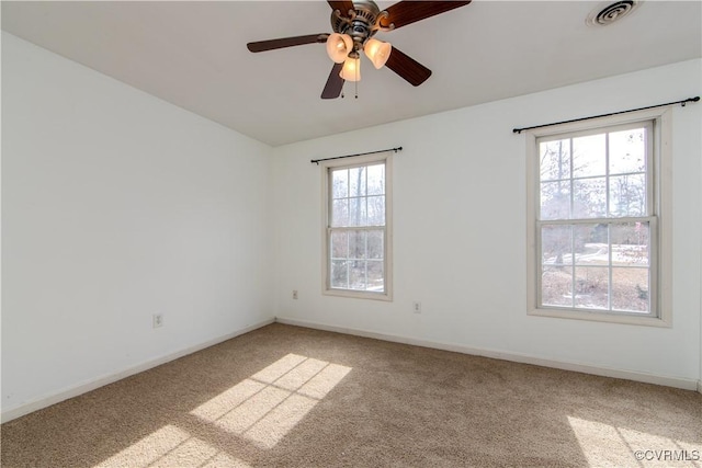 carpeted spare room with ceiling fan