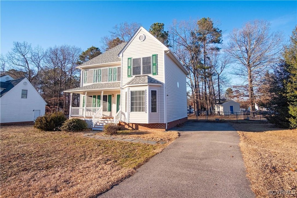 view of front property featuring a porch and a front lawn