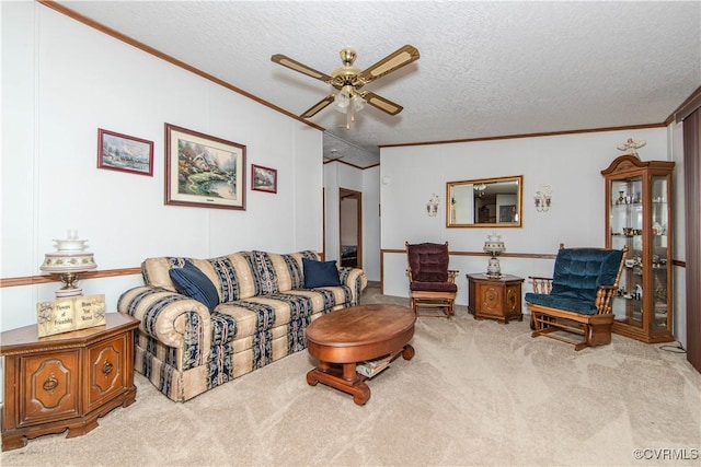 living room featuring crown molding, light carpet, ceiling fan, and a textured ceiling