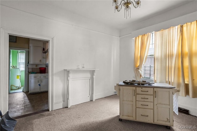 kitchen with light colored carpet and cream cabinets