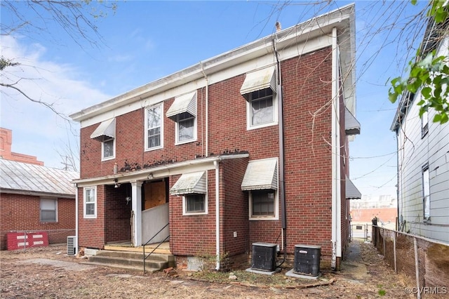 rear view of property with cooling unit