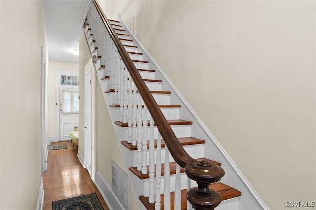 stairs featuring hardwood / wood-style flooring