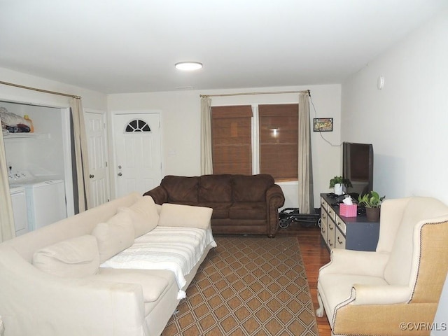 living room featuring dark wood-type flooring and separate washer and dryer