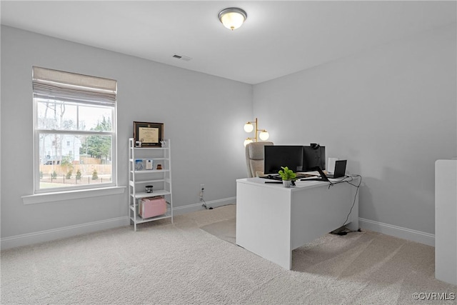 carpeted office with visible vents and baseboards