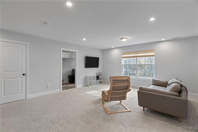 living room with carpet floors, visible vents, baseboards, and recessed lighting