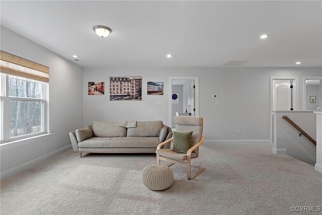 carpeted living room with recessed lighting and baseboards