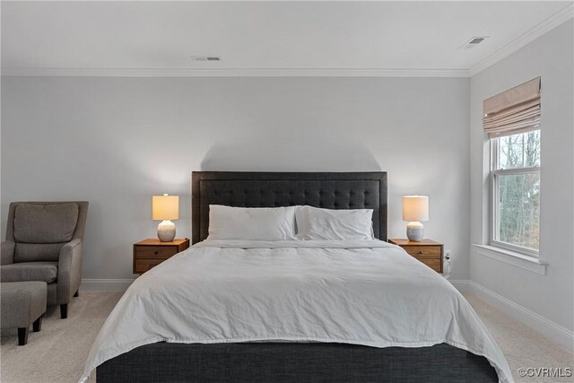 carpeted bedroom with baseboards, visible vents, and ornamental molding