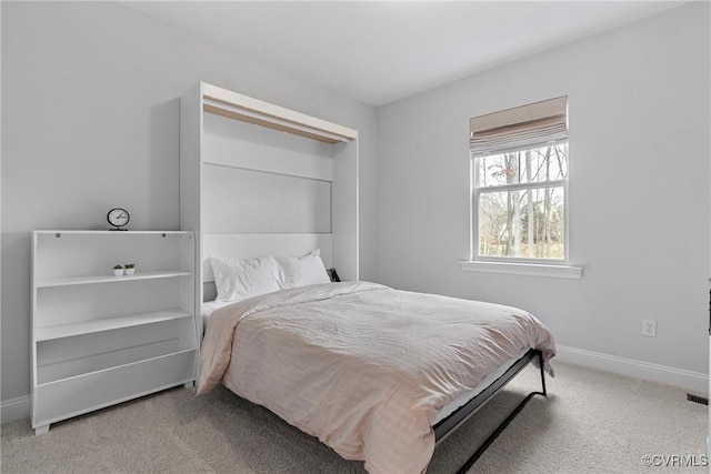 carpeted bedroom featuring baseboards