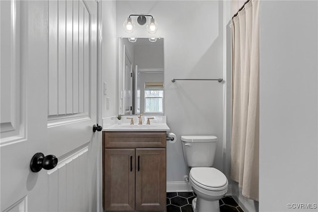 bathroom with toilet, tile patterned floors, curtained shower, and vanity