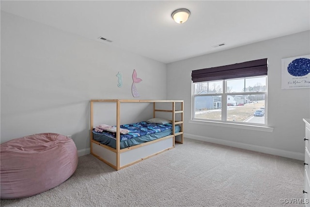 carpeted bedroom featuring baseboards and visible vents