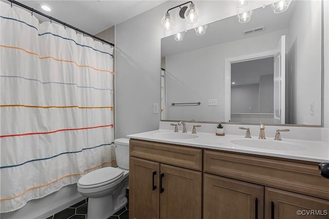 full bath featuring visible vents, a sink, toilet, and double vanity