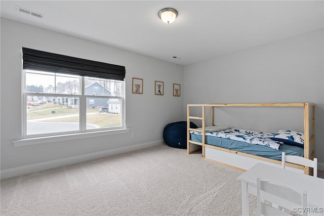 carpeted bedroom featuring baseboards and visible vents