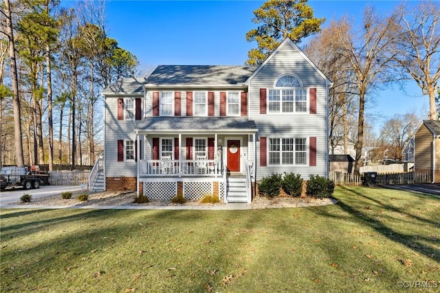 view of front of property with a porch and a front lawn