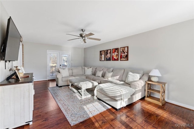 living room with dark wood-type flooring and ceiling fan