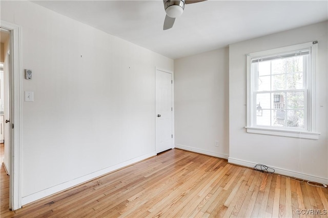 spare room with ceiling fan and light wood-type flooring